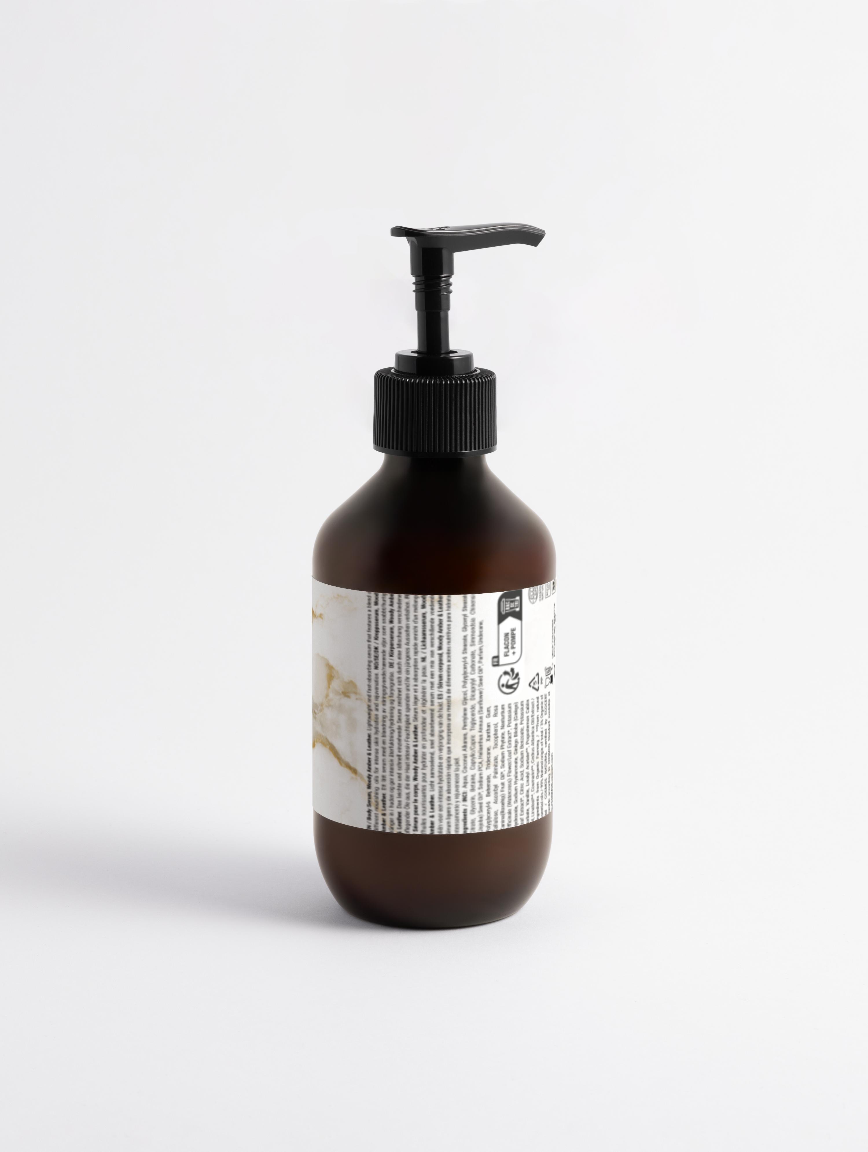 Eclat Soin Silk Skin Body Serum in a dark bottle with pump for smooth and hydrated skin